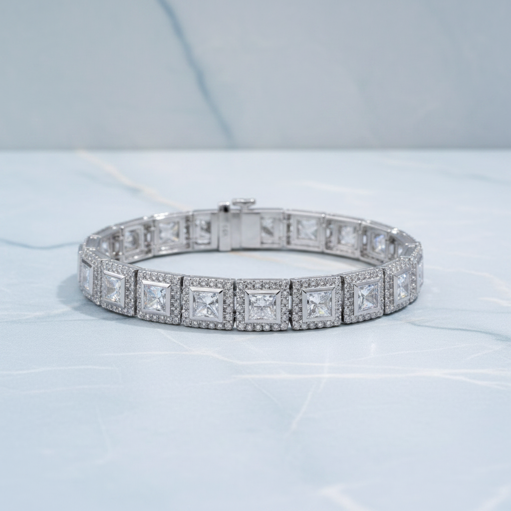 Diamond bracelet on a white surface with green foliage in the background