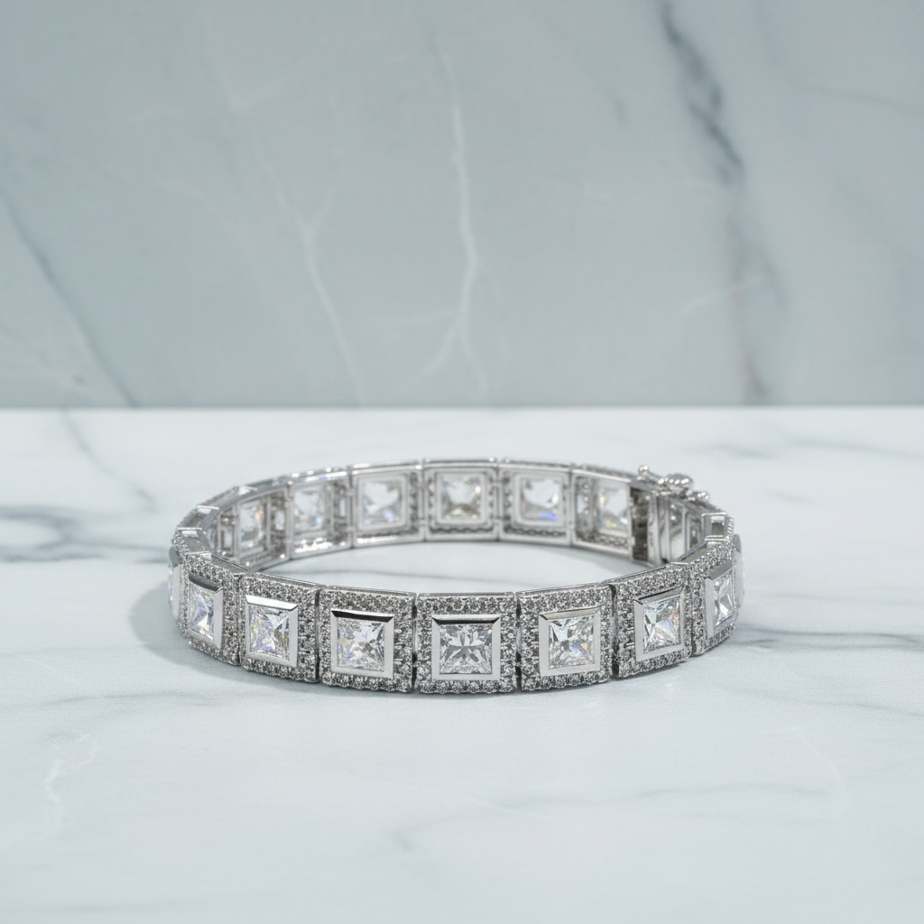Diamond bracelet on a white surface with green foliage in the background