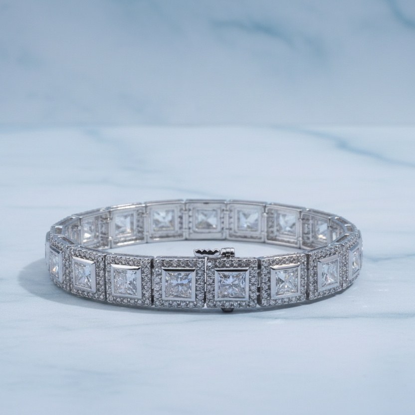 Silver bracelet with diamond accents on a white surface with green foliage in the background