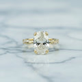 Gold ring with a large diamond on a light background