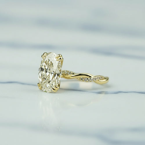 Gold ring with a large diamond on a light background